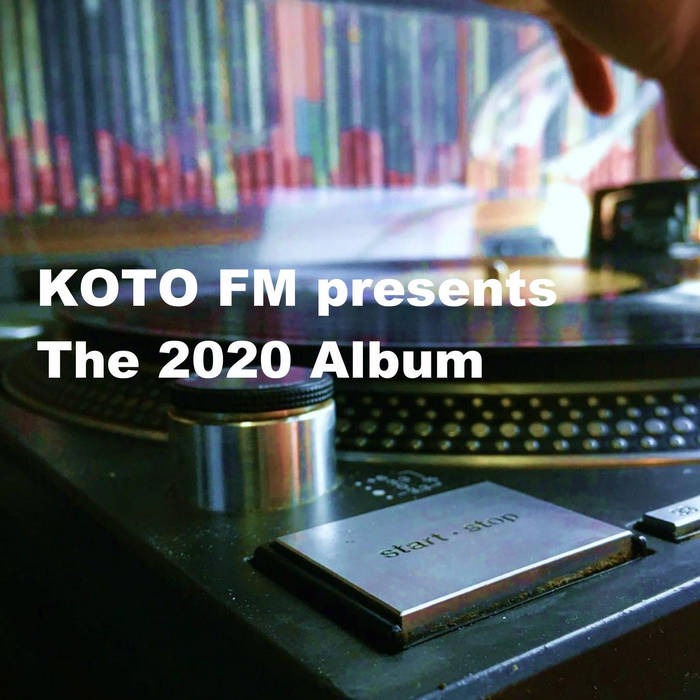 Close-up of a vintage record player with a vinyl spinning. Blurred colorful books are in the background. Text overlay reads, KOTO FM presents The 2020 Album. A hand is adjusting the record player.