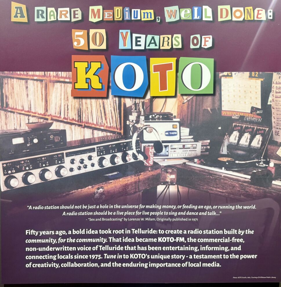 Colorful poster celebrating 50 Years of KOTO radio station, featuring vintage audio equipment and highlighting the importance of community radio in lifting all boats through its rich history and local impact.